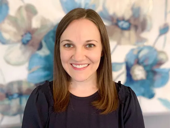 Image of woman wearing black shirt smiling at camera