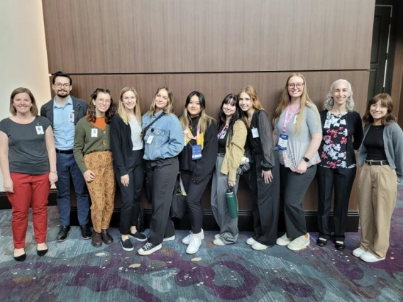 Two Audiology faculty and 9 grad students in group photo 