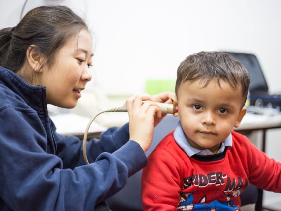 Graduate clinician works with a child