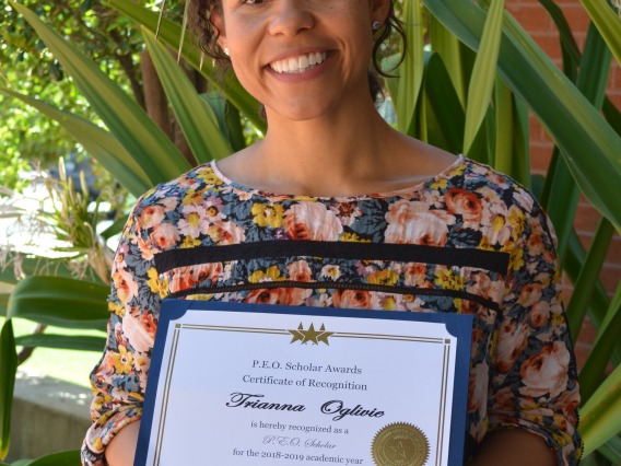 Trianna Oglivie holding her PEO Award