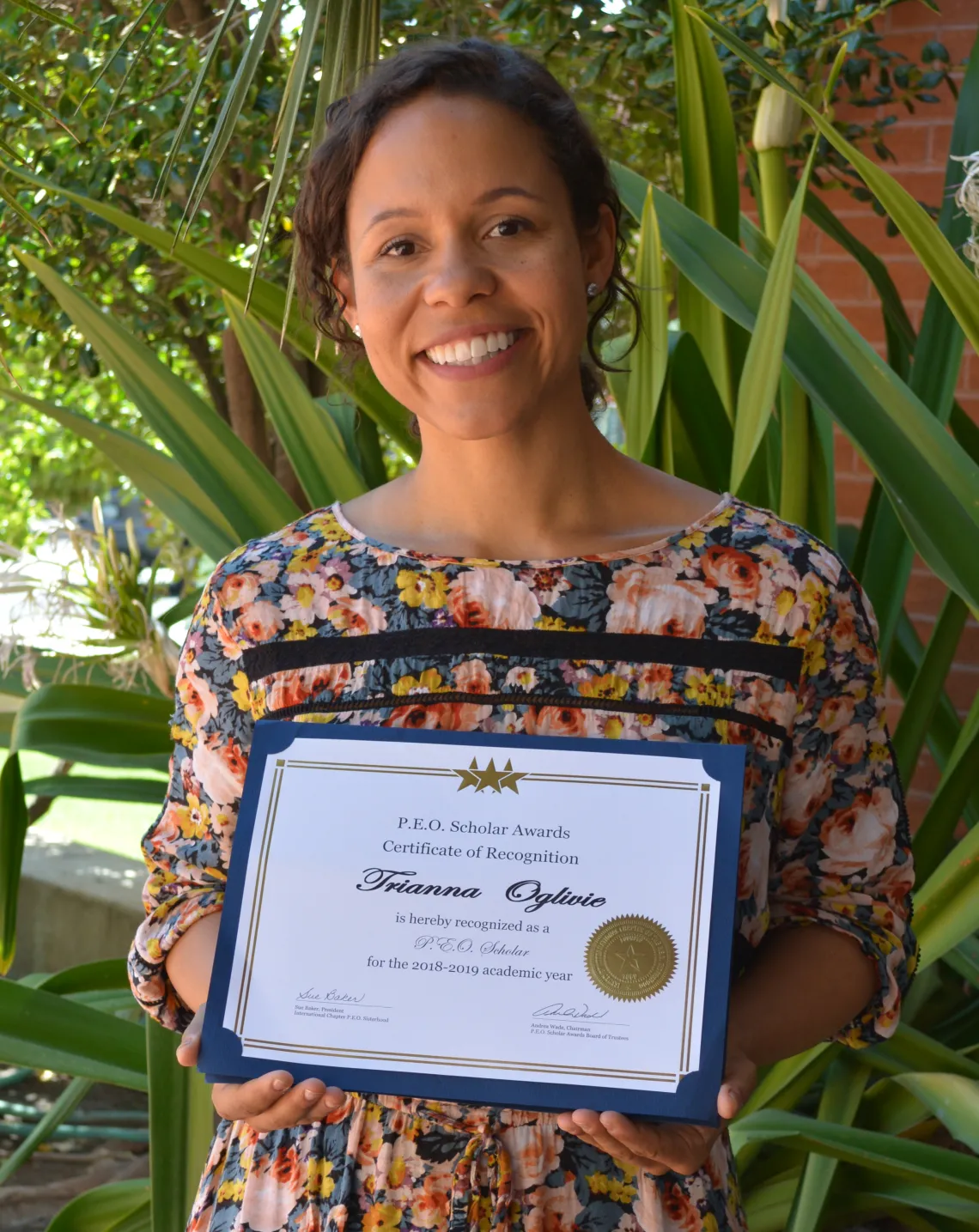 Trianna Oglivie holding her PEO Award