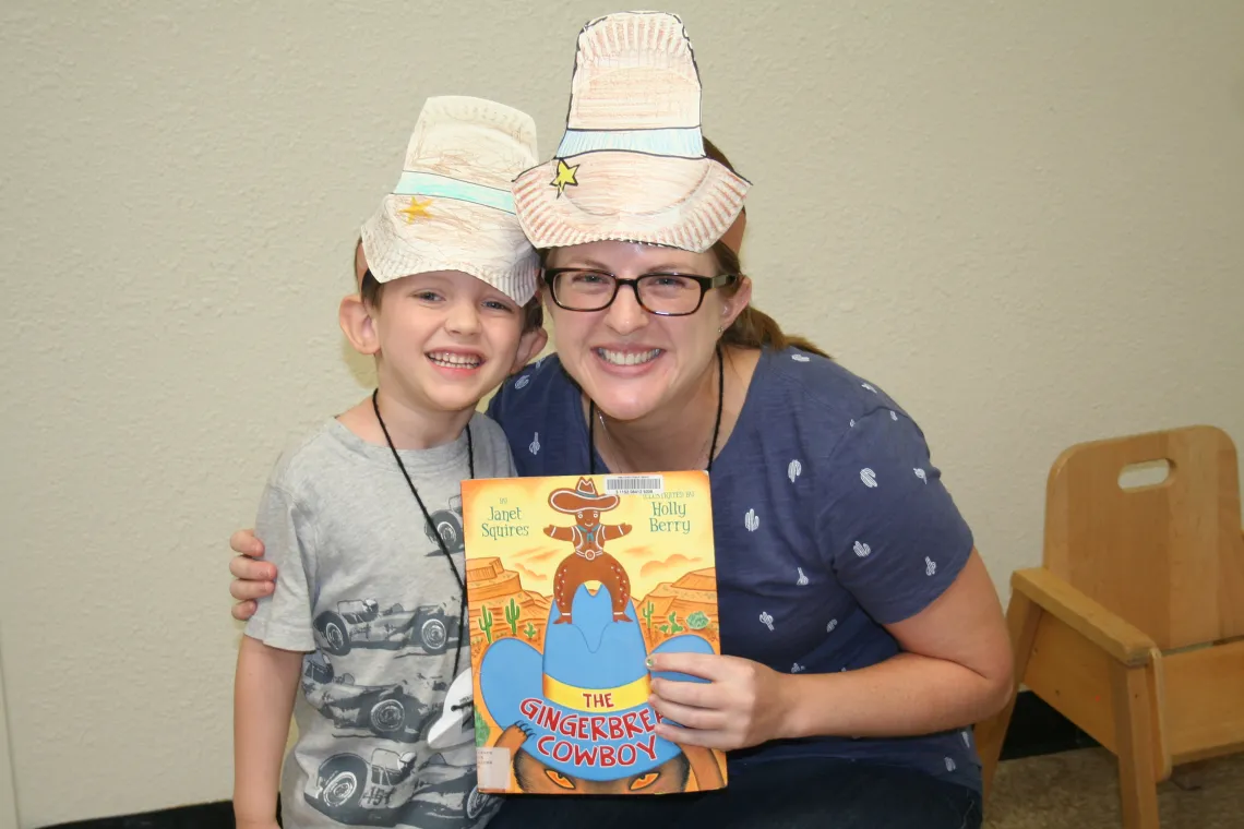 PhD student with camper holding book