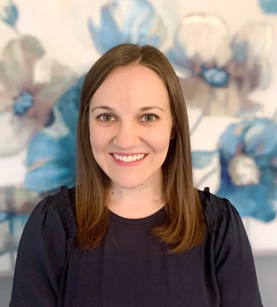 Image of woman wearing black shirt smiling at camera