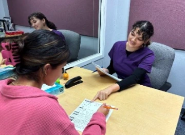 Dr. Kielar lab photo; student sitting across from a person filling out a worksheet