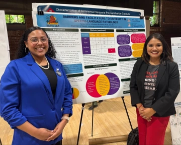 Student researcher with faculty advisor in front of research poster